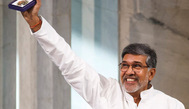 FILE - In this Dec. 10, 2014 file photo, Nobel Peace Prize joint-winner Kailash Satyarthi of India holds up his Nobel Peace Prize medal during the Nobel Peace Prize award ceremony in Oslo, Norway. Police say Satyarthi's apartment in the Indian capital has been burgled and a gold-plated replica of his medal and the citation have been found missing. His son, Bhuvan Ribhu, says the theft occurred Monday, Feb. 6, 2017, night while his father and mother were on a visit to Panama. (AP Photo/Cornelius Poppe, NTB Scanpix) NORWAY OUT